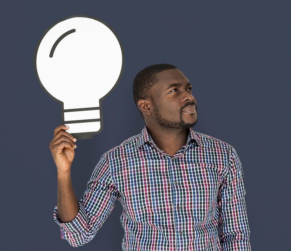 African Descent man holding light bulb