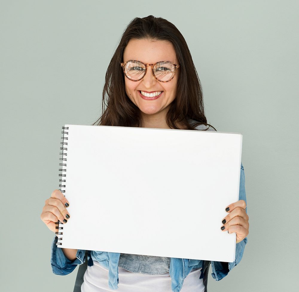 Young woman holding placard blank board
