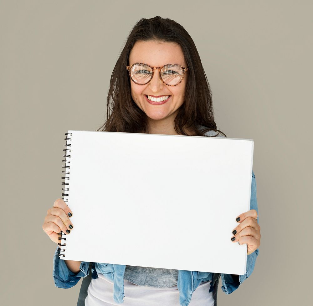 Young woman holding placard blank board