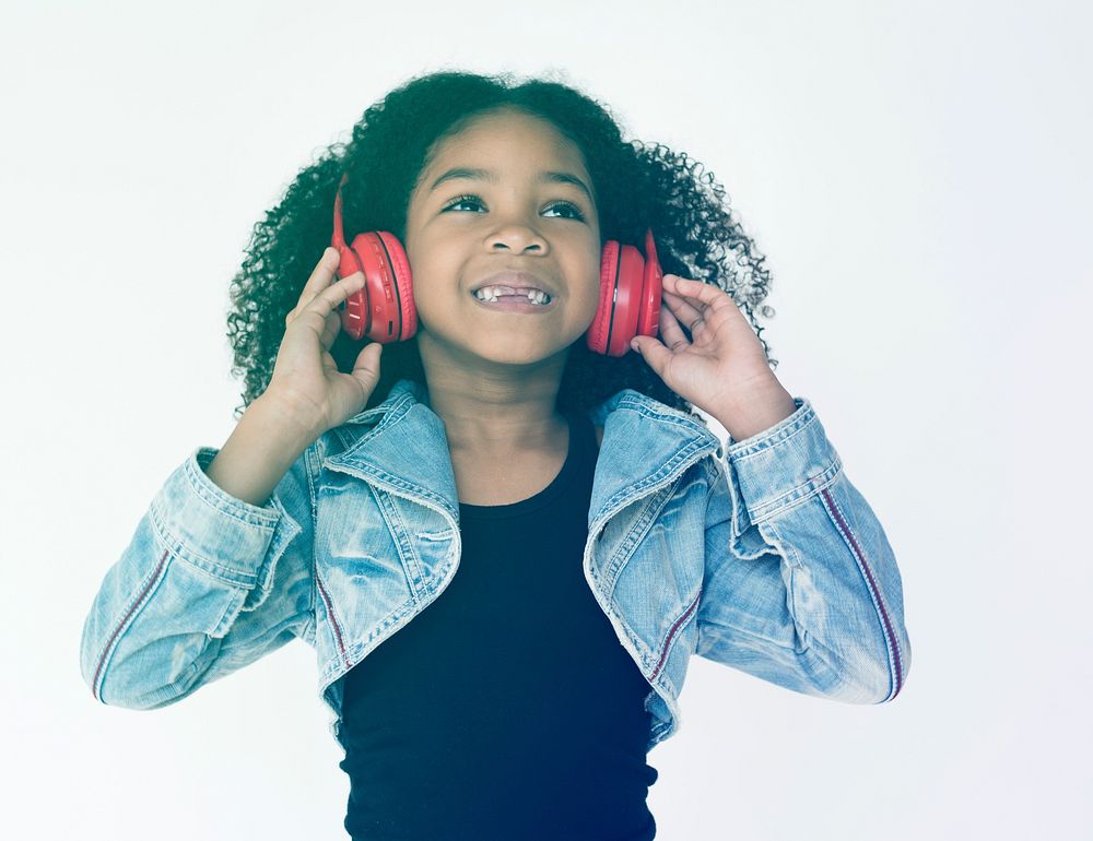 Little Girl Listening to Music Enjoyment with Headphone Studio Portrait