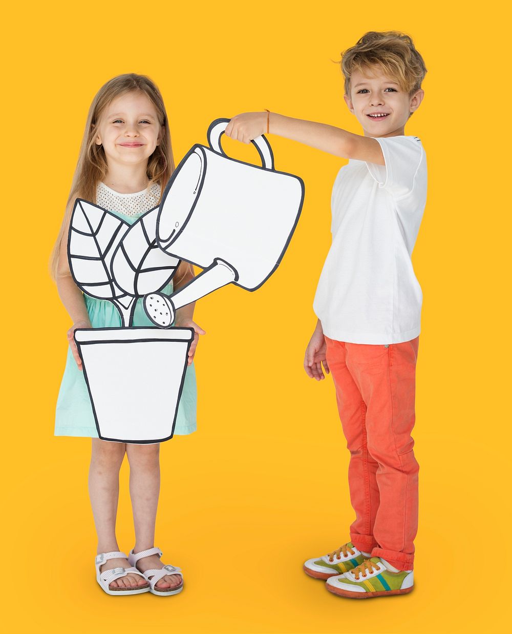 Boy and girl holding gardening paper cutout props