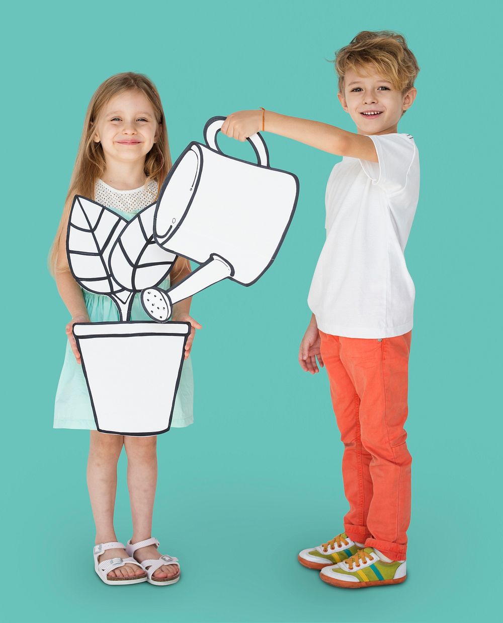 Boy and girl holding gardening paper cutout props