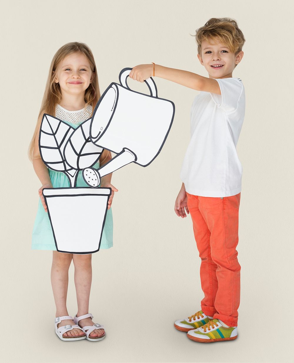 Boy and girl holding gardening paper cutout props