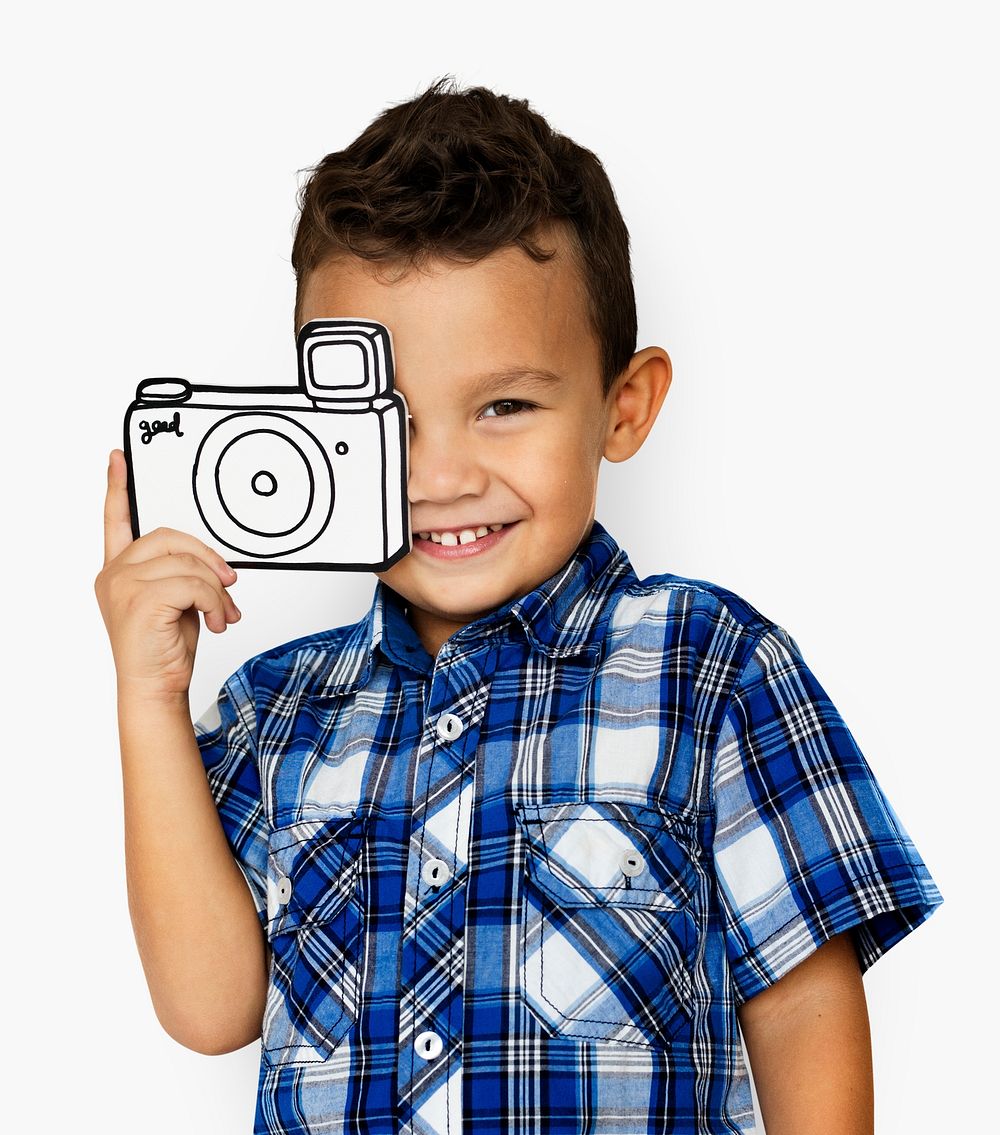 Little boy smiling and holding a paper camera