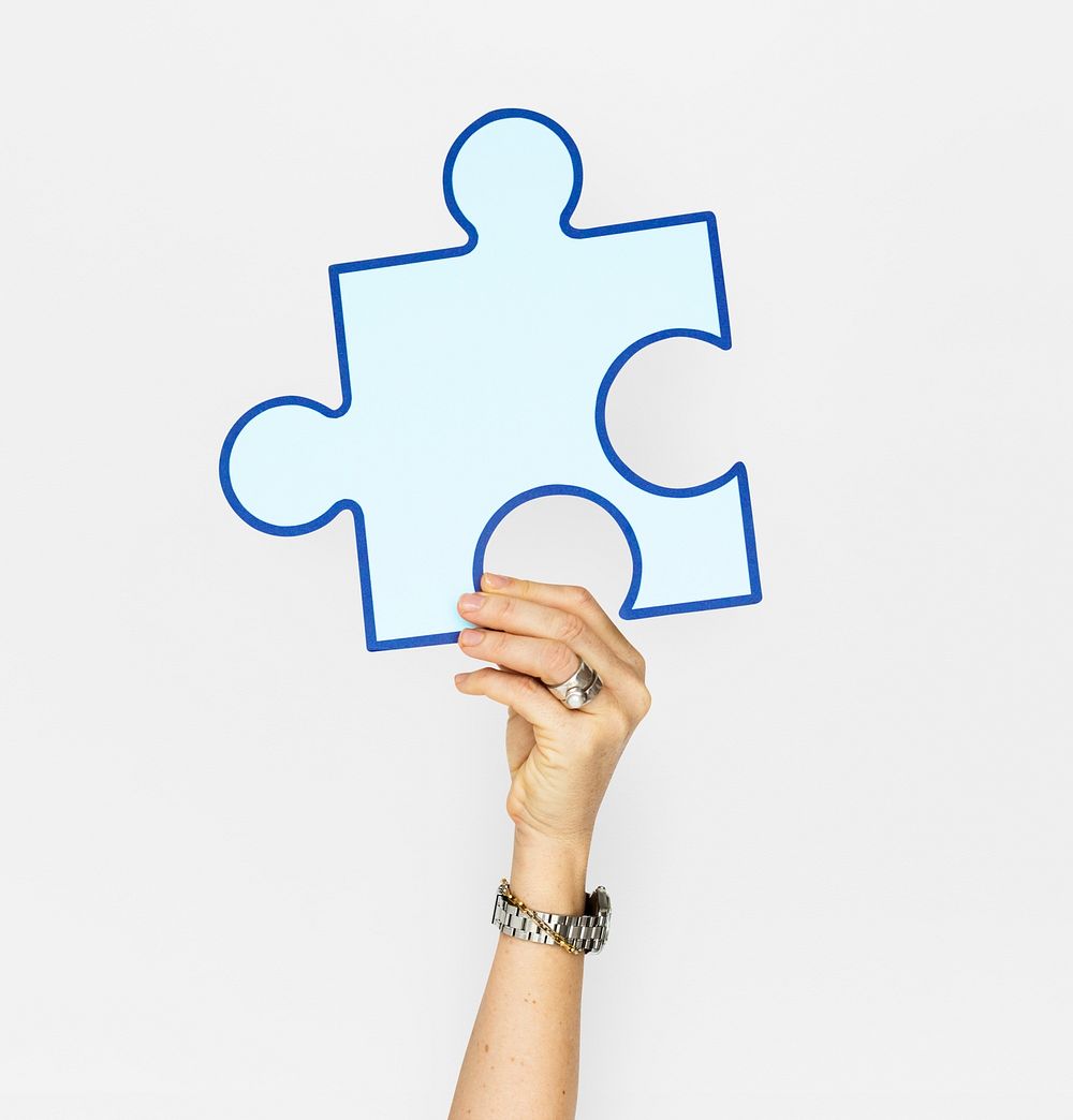 Human Hand Holding Puzzle Piece