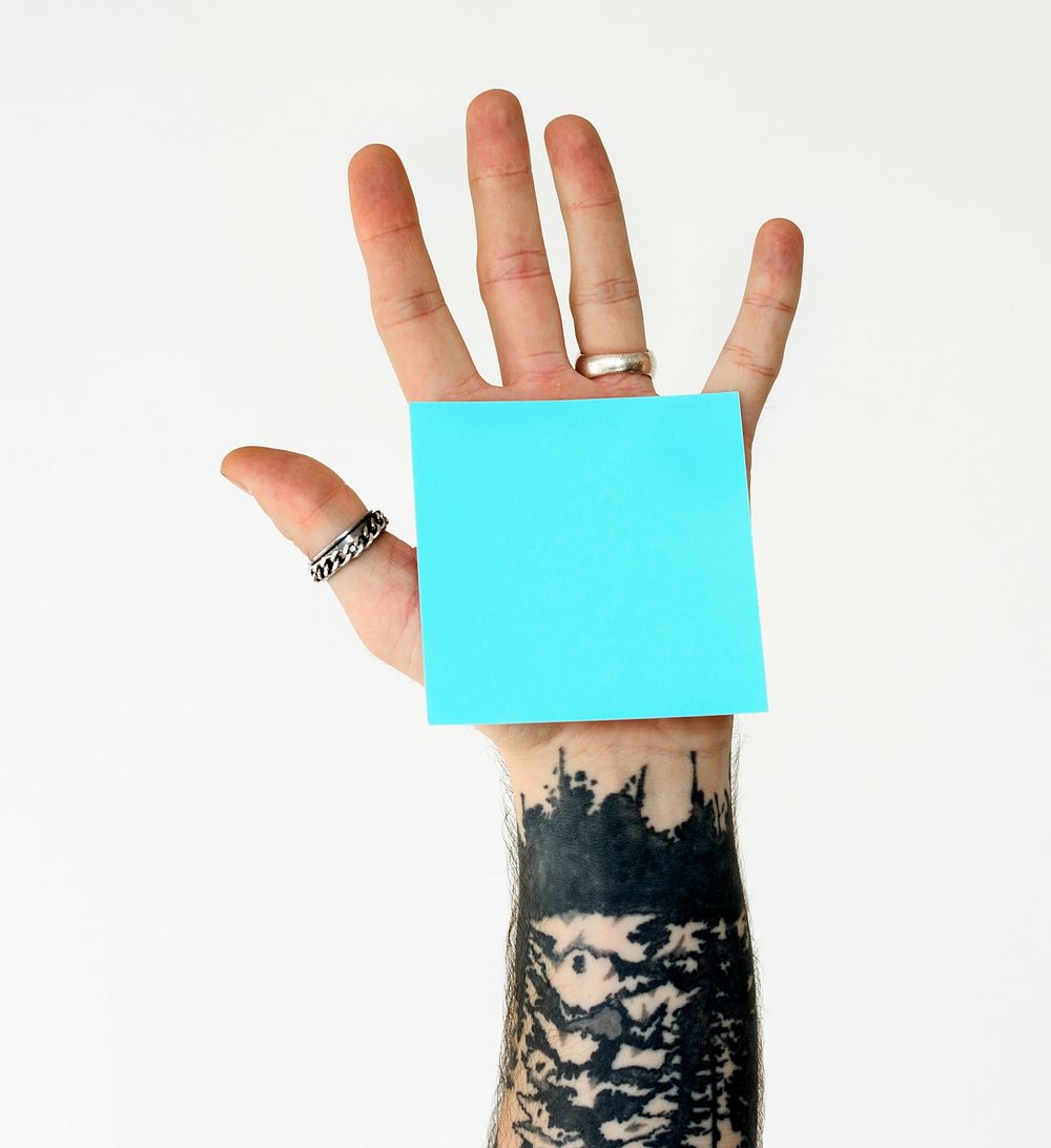 Hand with a sticky note on the palm