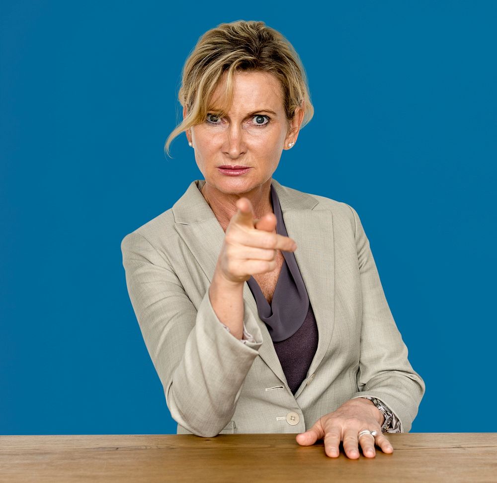 Businesswoman in a studio with wooden table