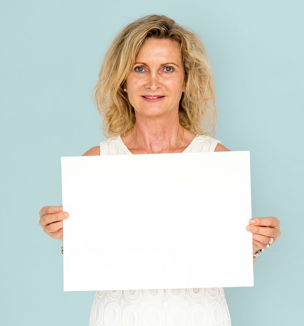 Caucasian blonde woman holding placard