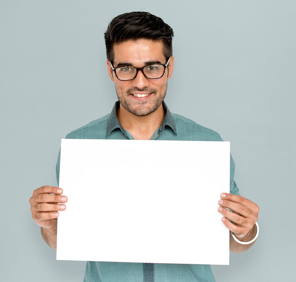 Man in a studio shoot holding placard