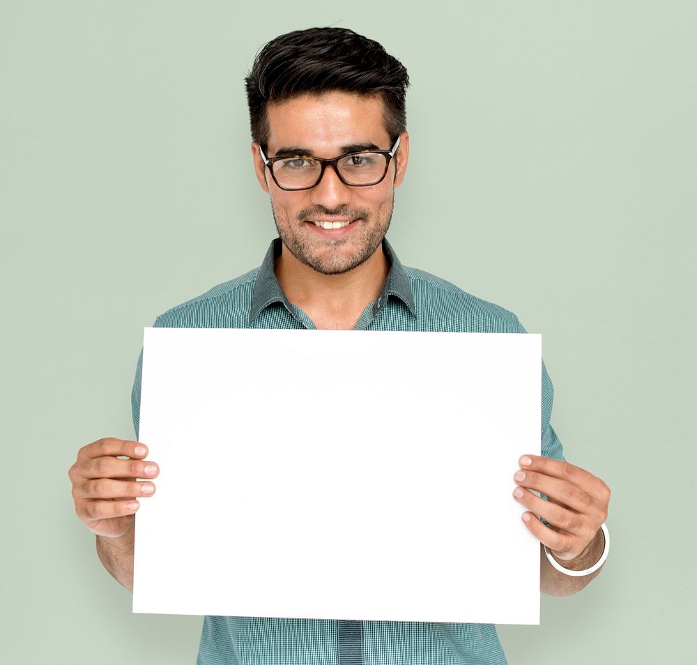 Man in a studio shoot holding placard