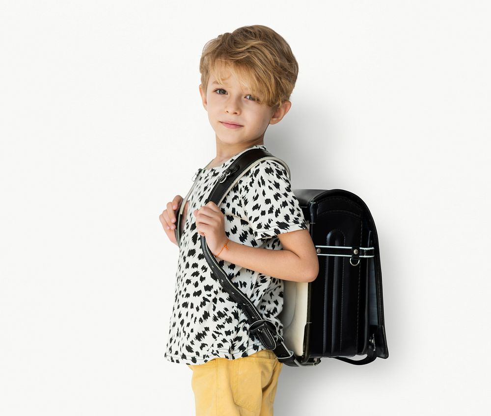 Young blonde boy carrying a backpack portrait