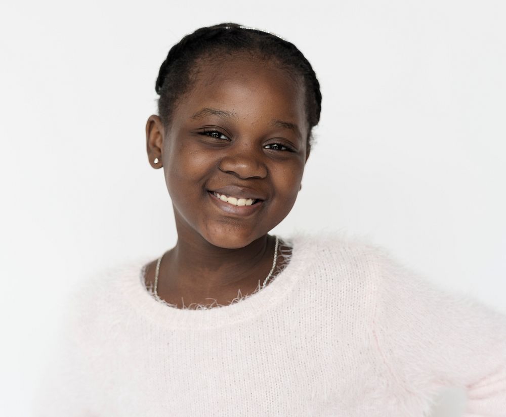African descent girl is smiling to a camera.