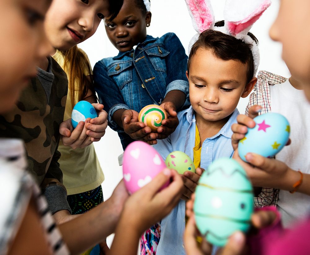 A group of little kids showing their easter eggs to one another