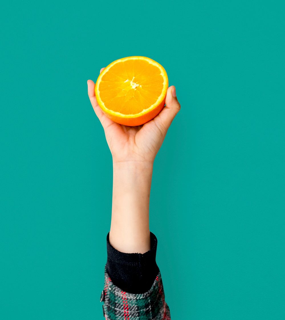 Hand Holding Orange Isolated Concept