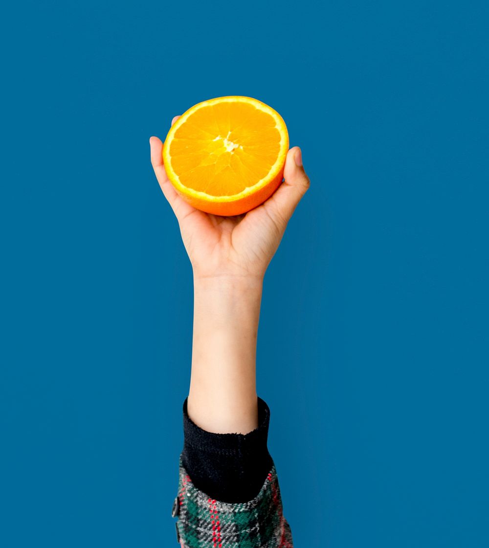 Hand Holding Orange Isolated Concept