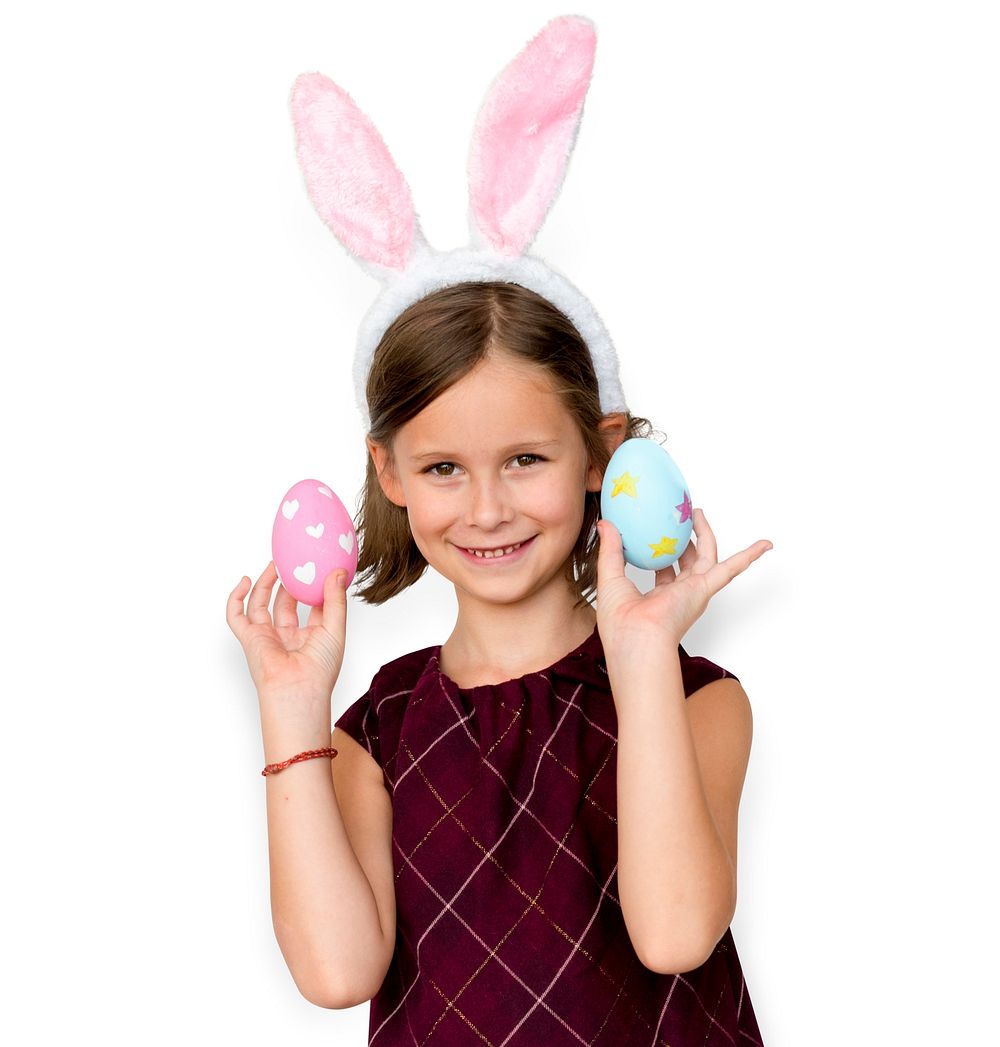 Kid with a bunny hairband holding eggs