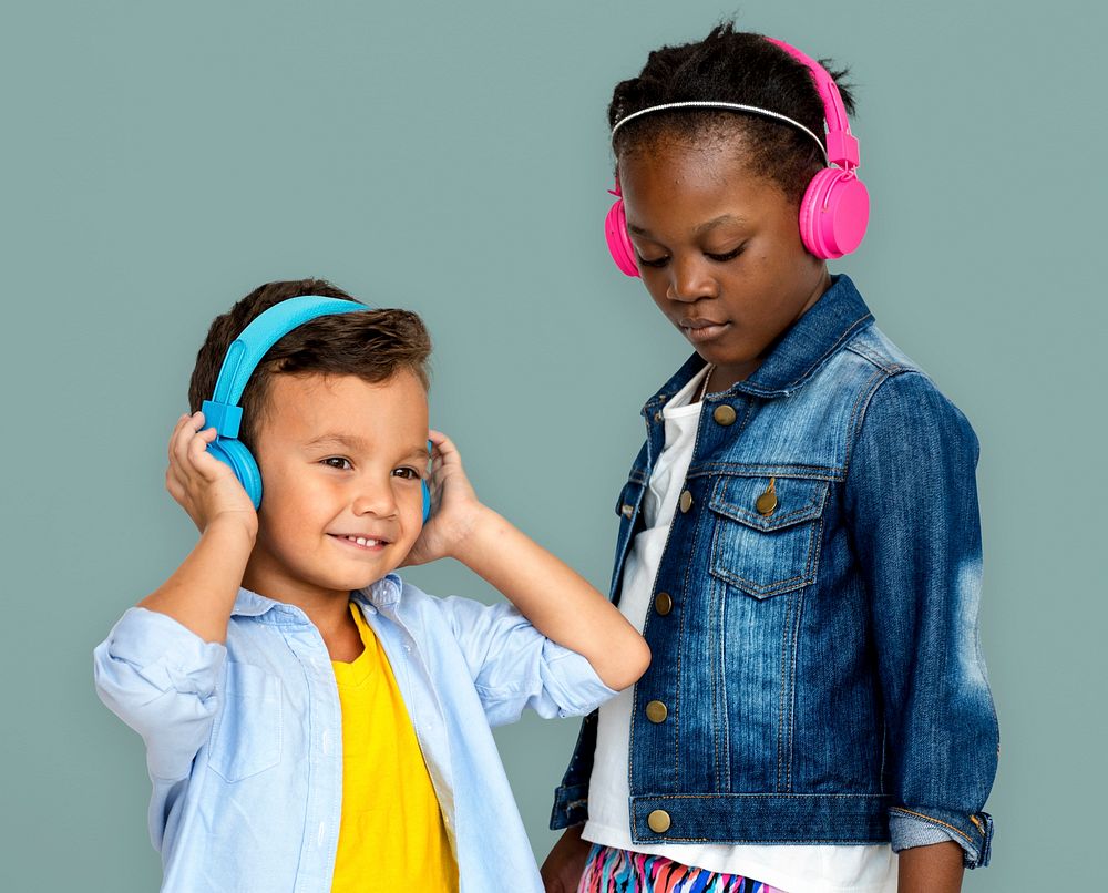 Kids enjoying listening to music with headphones