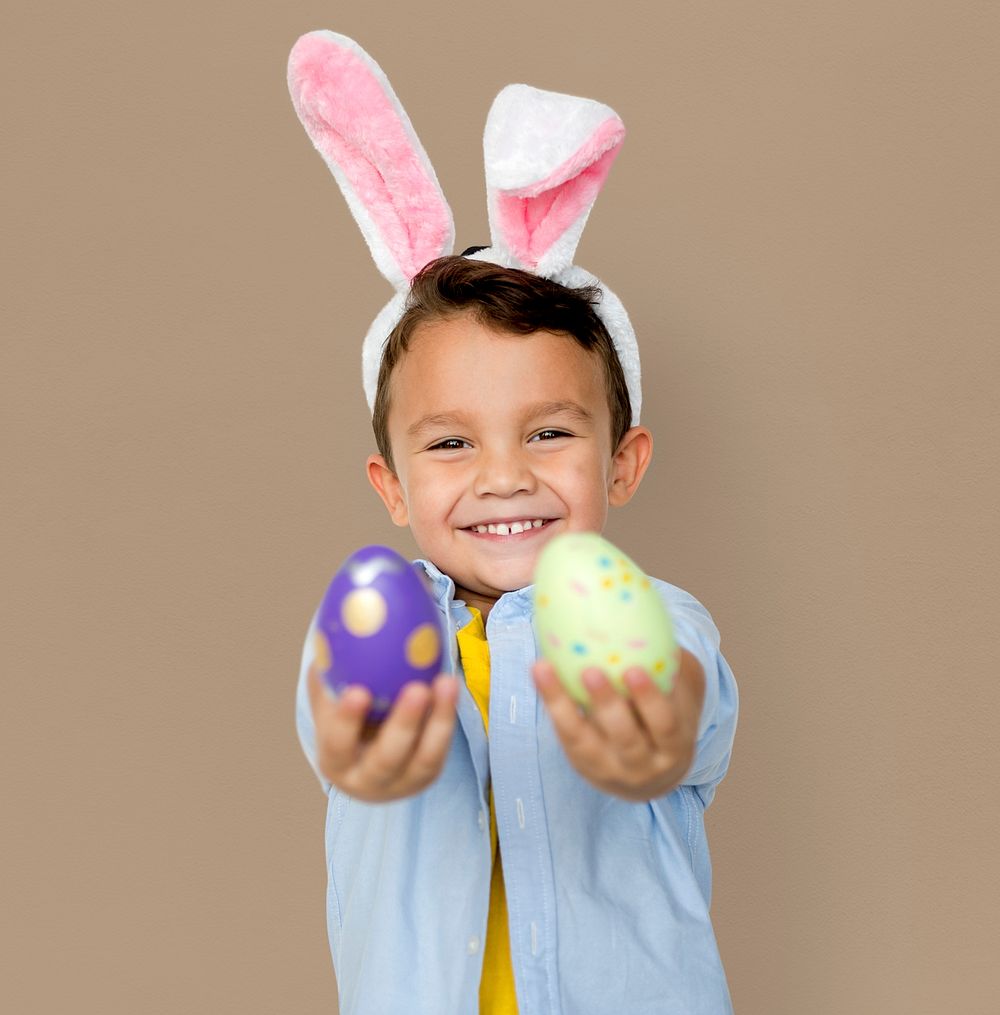 A boy with bunny hairband and easter eggs