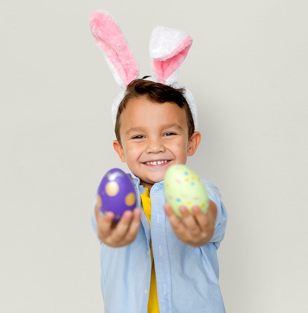 A boy with bunny hairband and easter eggs