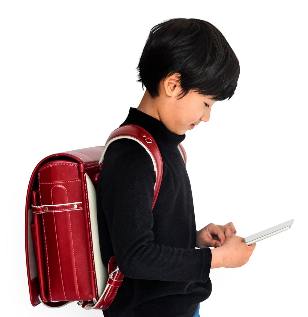 Young asian kid with a backpack using a tablet isolated portrait