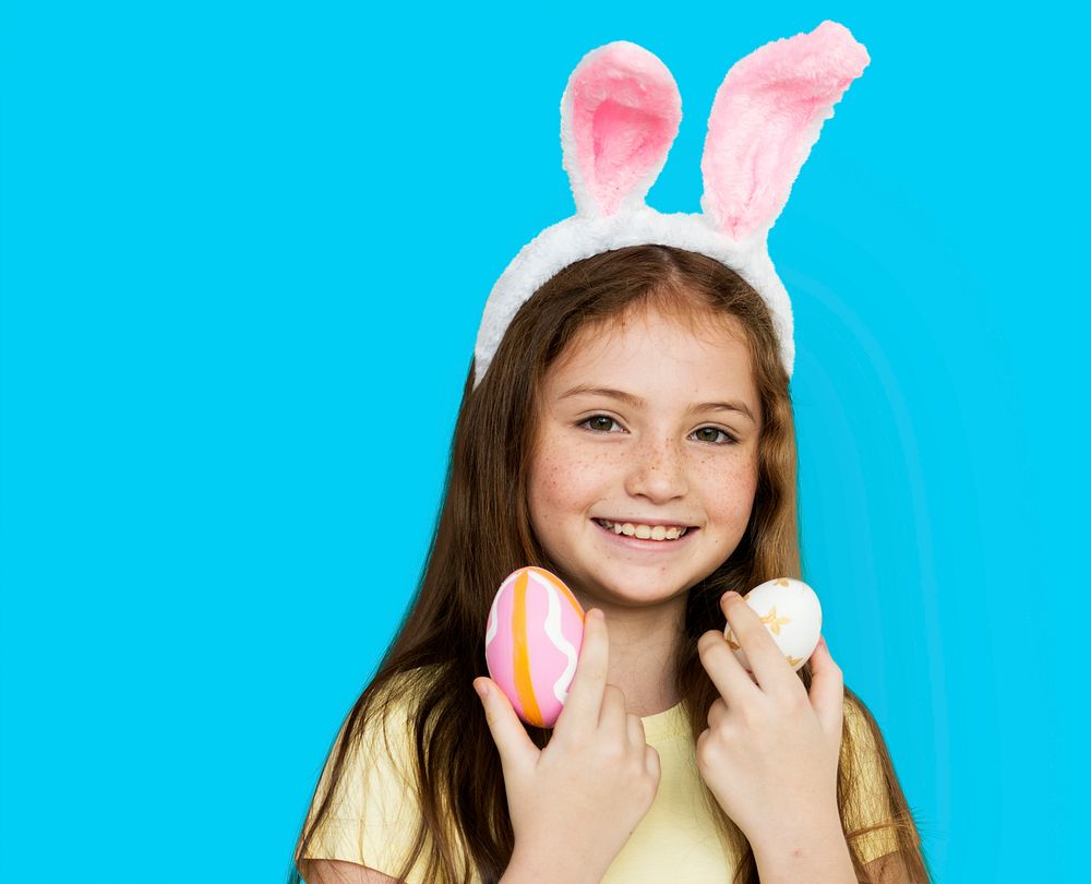 Children with bunny hairband and easter eggs