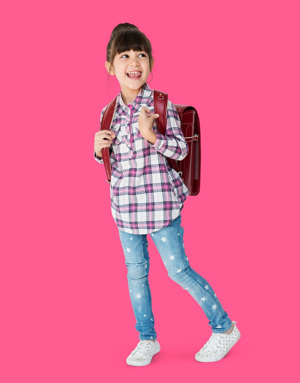A girl with backpack is smiling