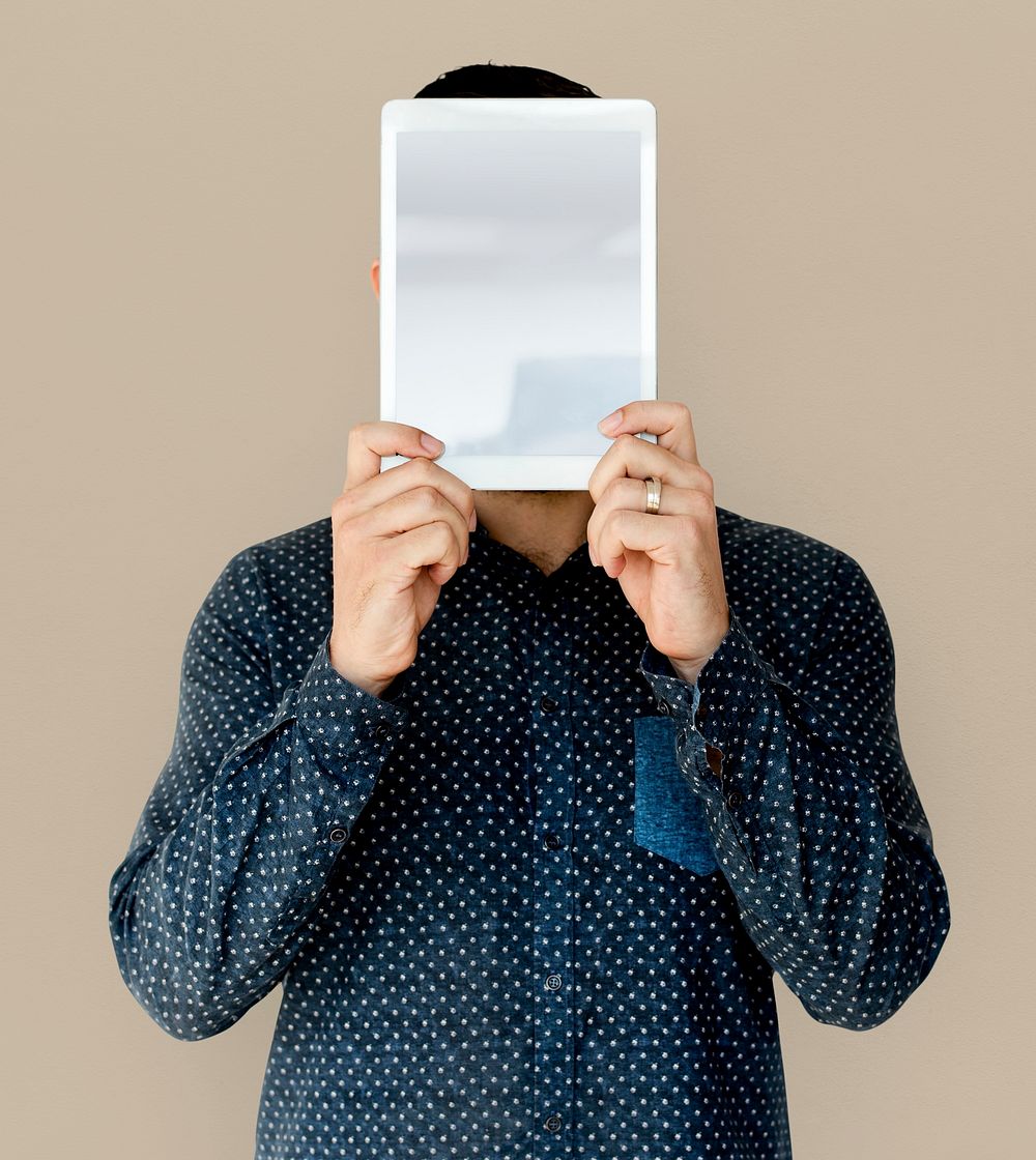 Man holding blank digital tablet cover face studio portrait