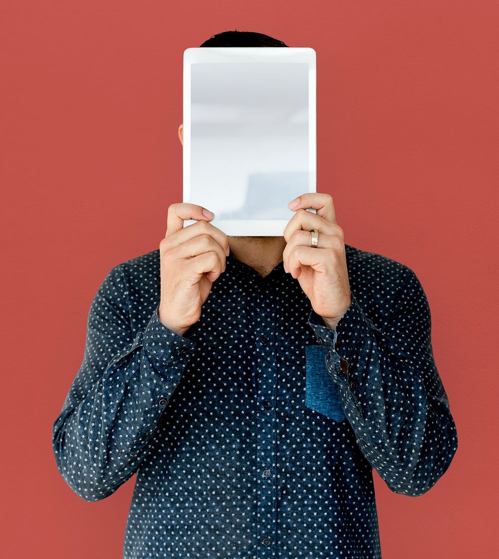 Man holding blank digital tablet cover face studio portrait