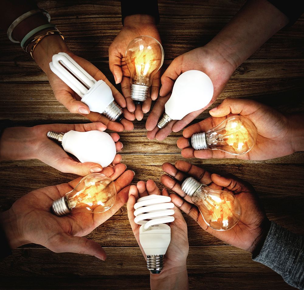 People holding light bulbs in their hands