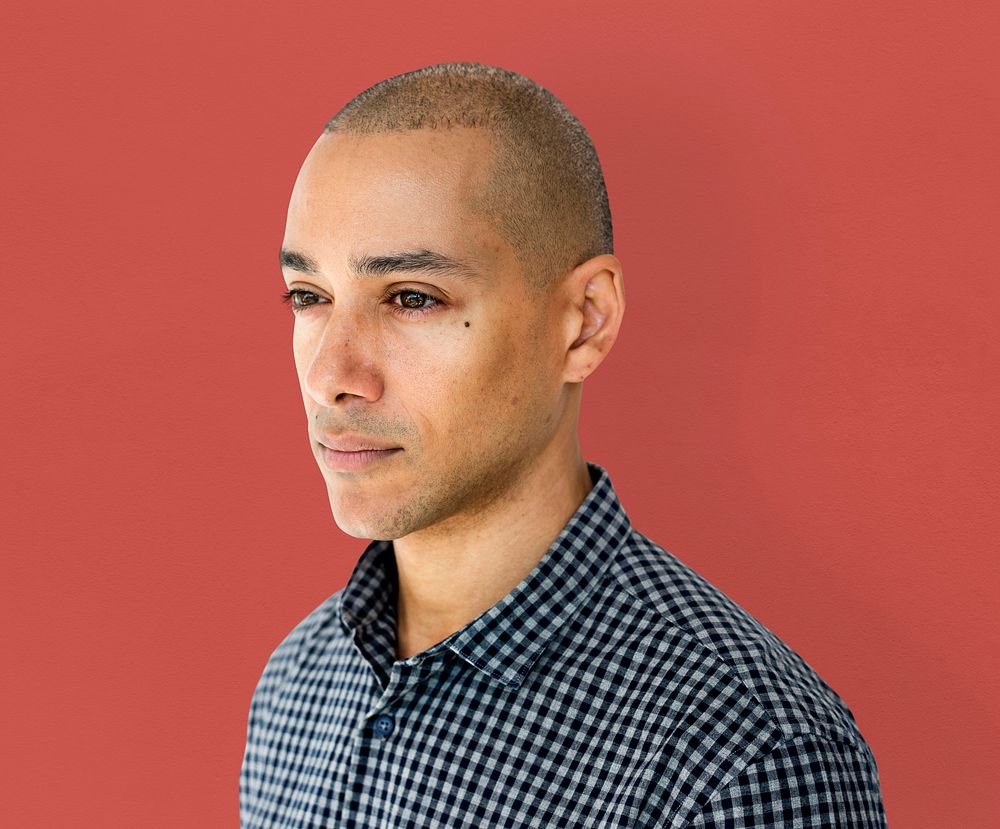 Skinhead man wearing checkered shirt studio shoot