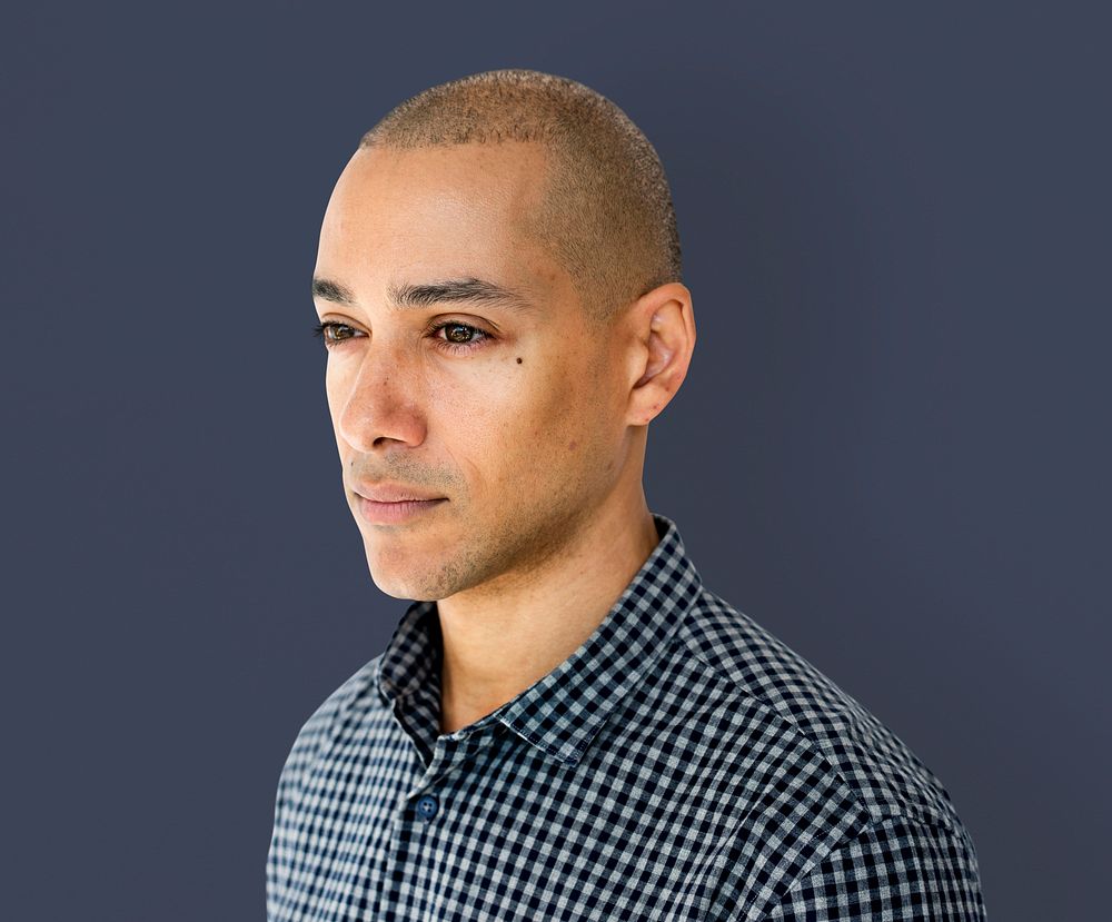 Skinhead man wearing checkered shirt studio shoot