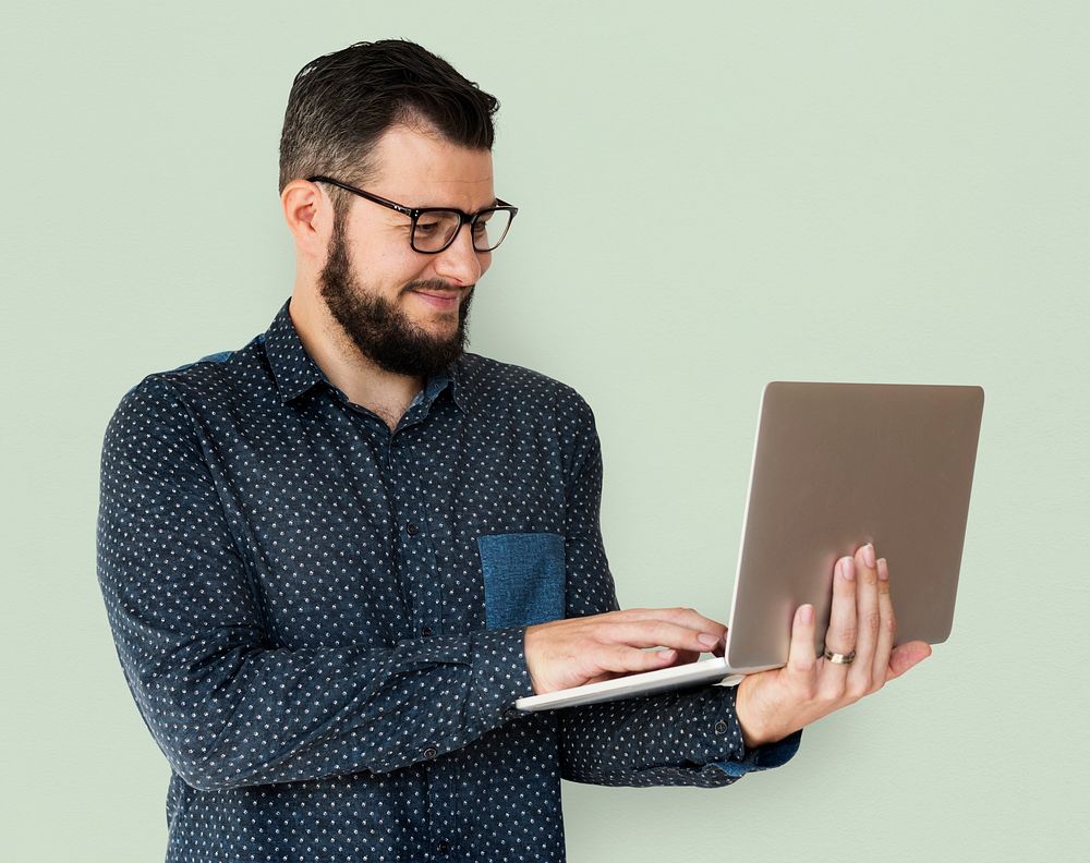 Man standing and holding laptop posing for shotoshoot