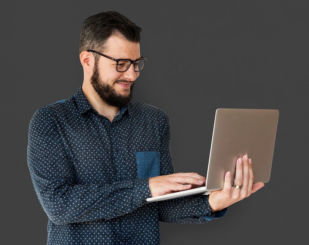 Man standing and holding laptop posing for shotoshoot