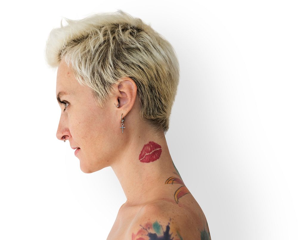 Profile portrait of a blonde woman with tattoos