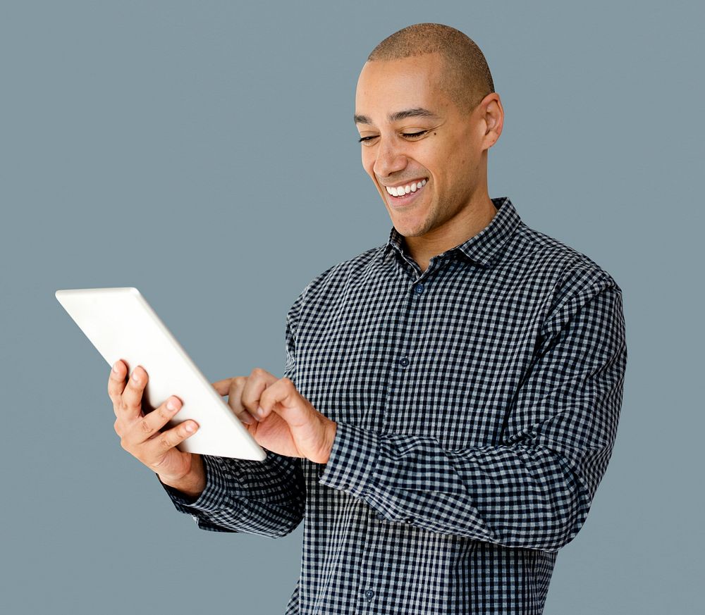 A guy is smiling using tablet