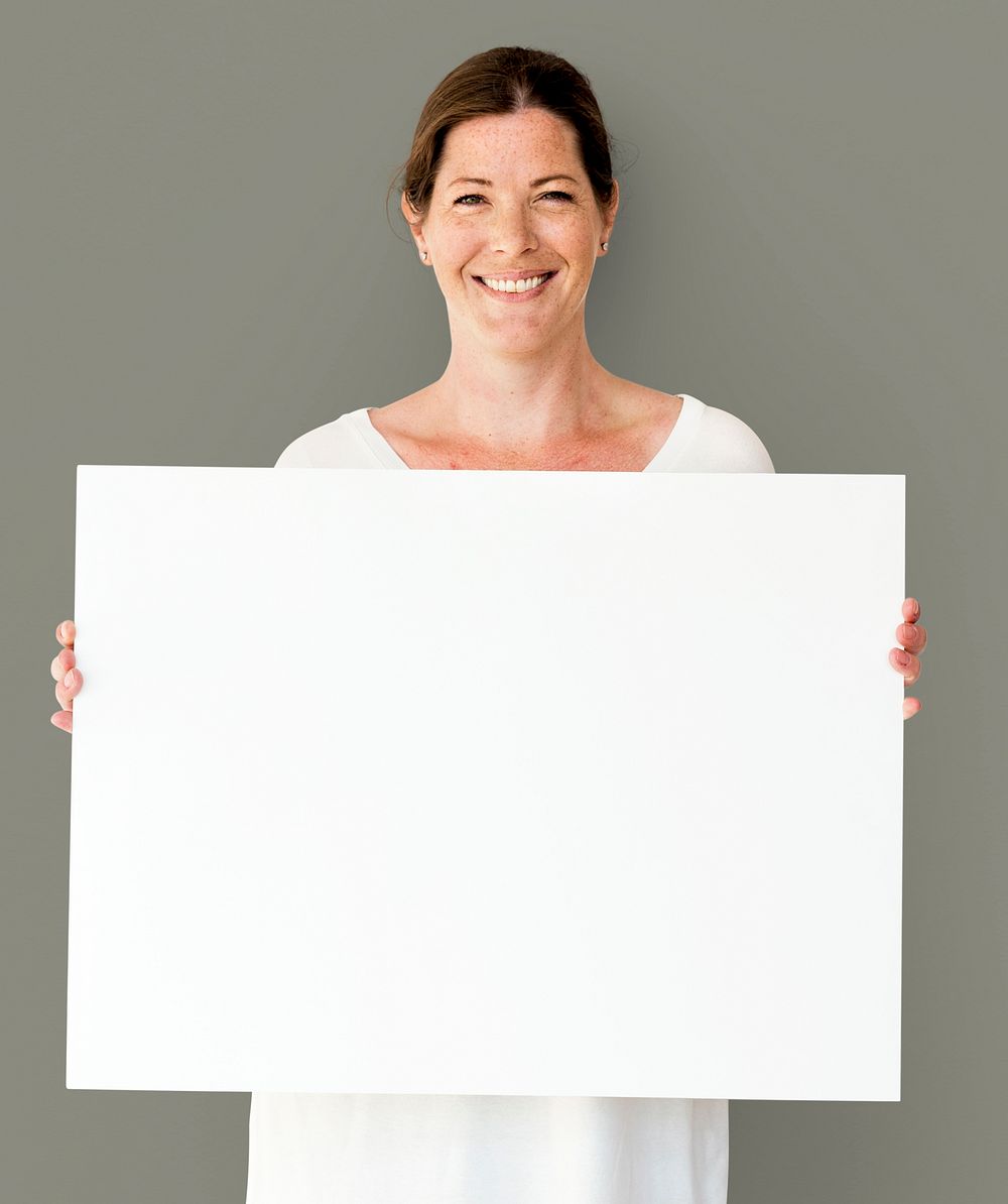 Caucasian Woman is Holding Placard