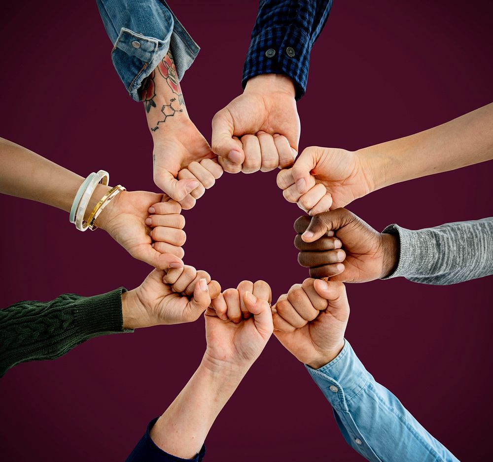 Group of people fist bump assemble together