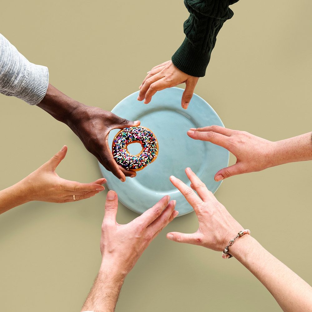 Group of Hands reaching for a donut