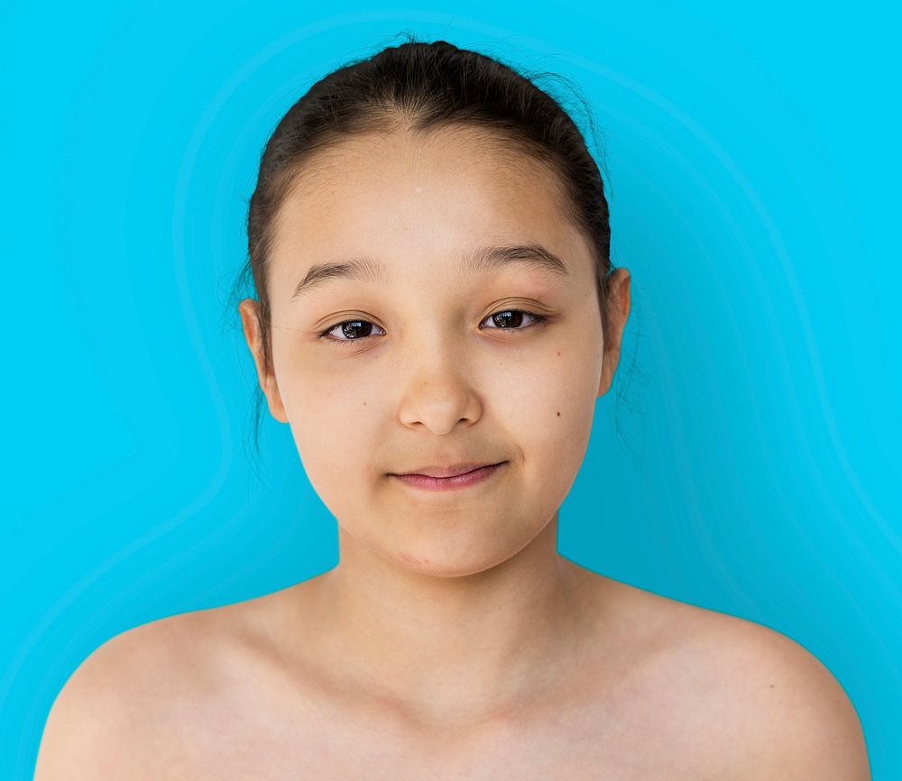 Little girl smiling bare chest studio portrait