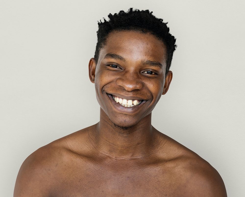 Happiness african man smiling bare chest studio portrait
