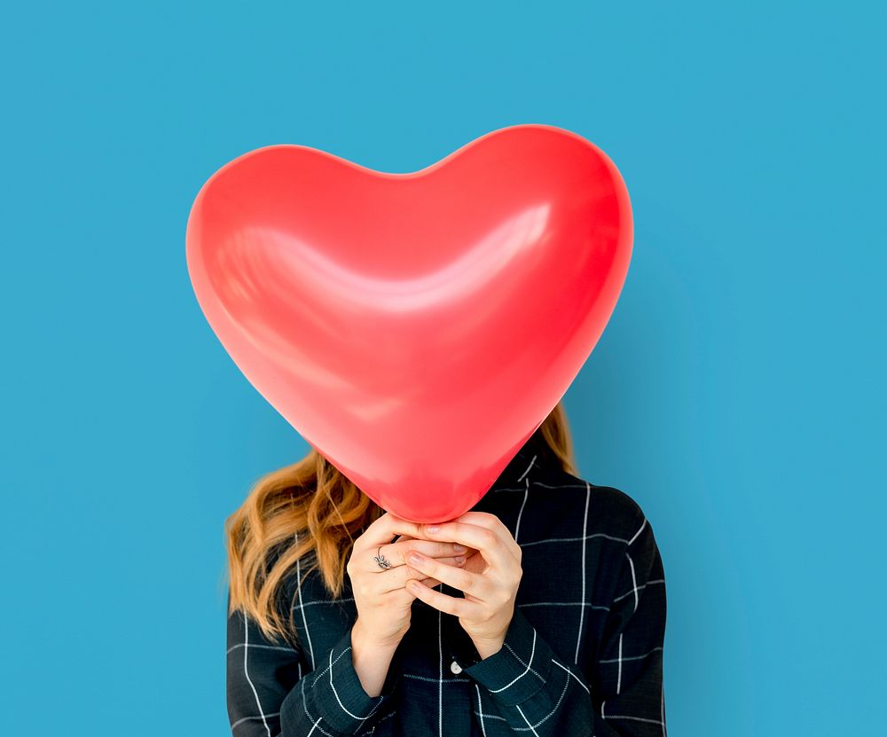 Young Adult Woman Face Covered with Heart Balloon