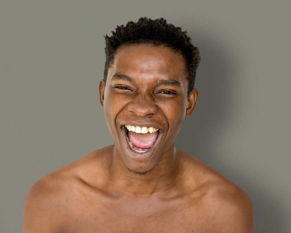 Happiness african man smiling bare chest studio portrait