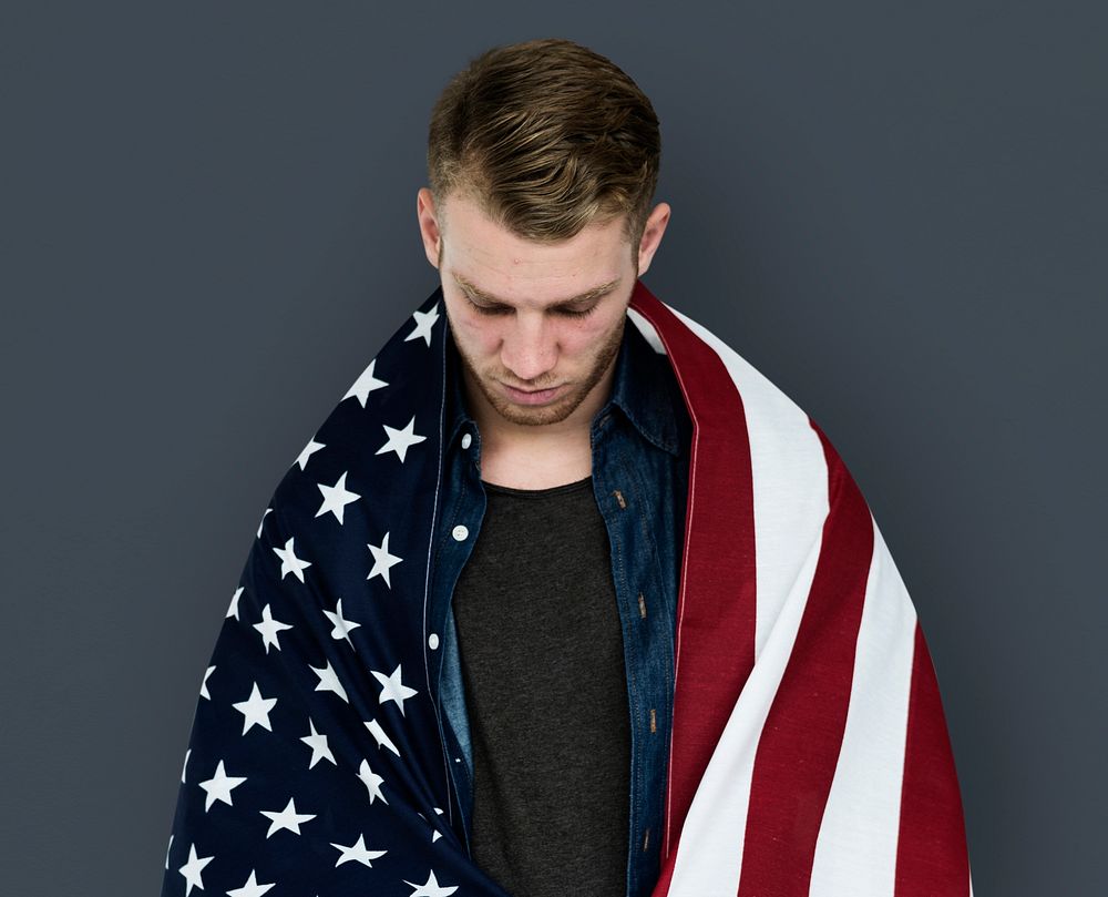 Man close up holding flag around shoulder posing for photoshoot