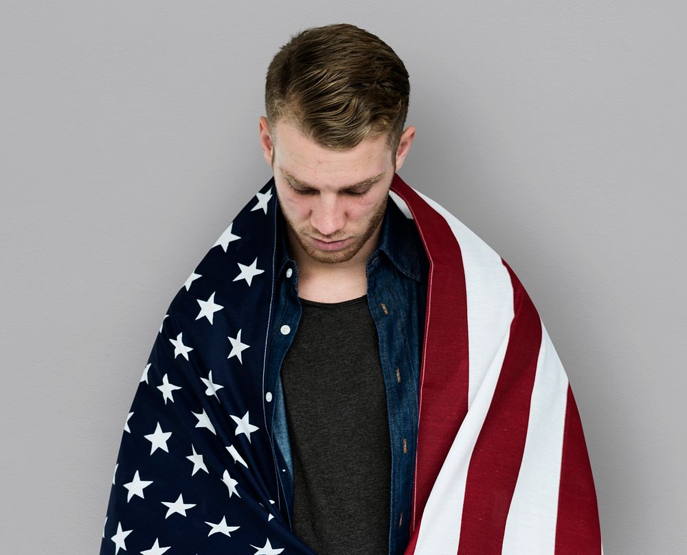 Man close up holding flag around shoulder posing for photoshoot