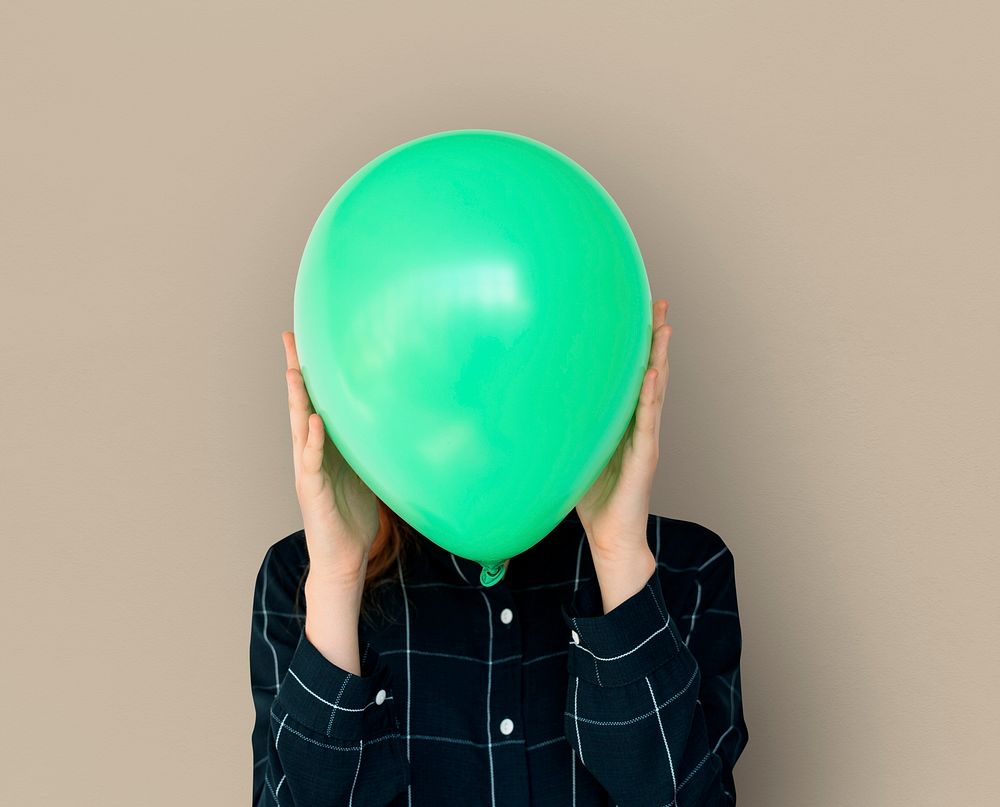 Woman close up holding balloon and posing for photoshoot