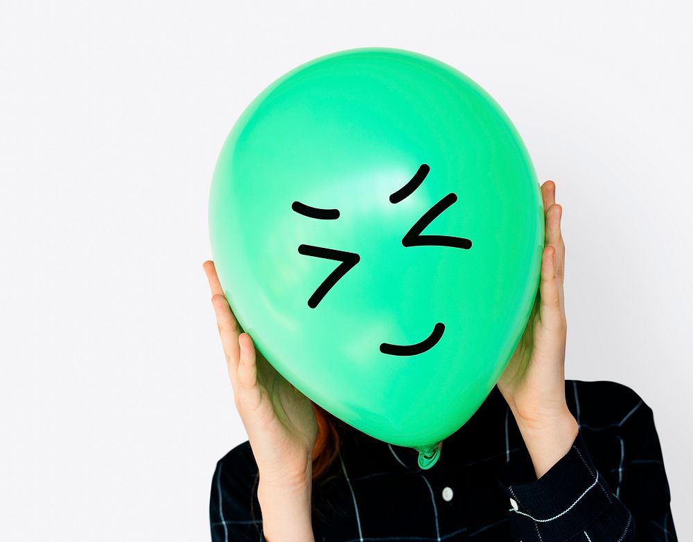 Hiding behind a smiley balloon