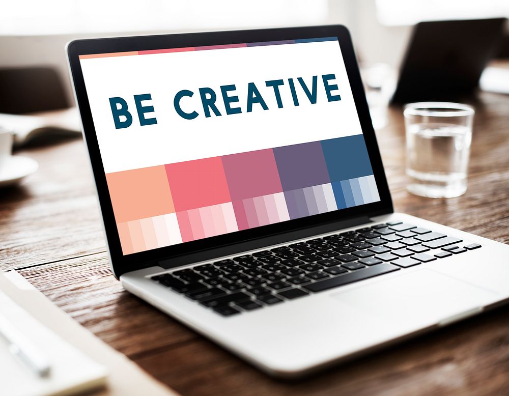 Laptop screen showing "Be Creative"