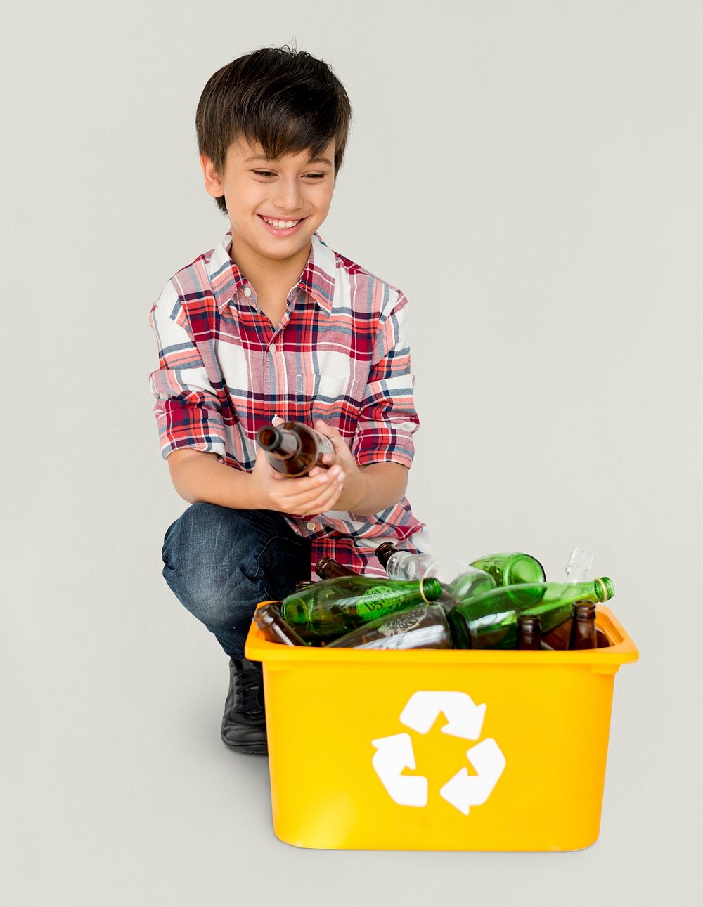 Young Boy Separating Recyclable Glass Bottles