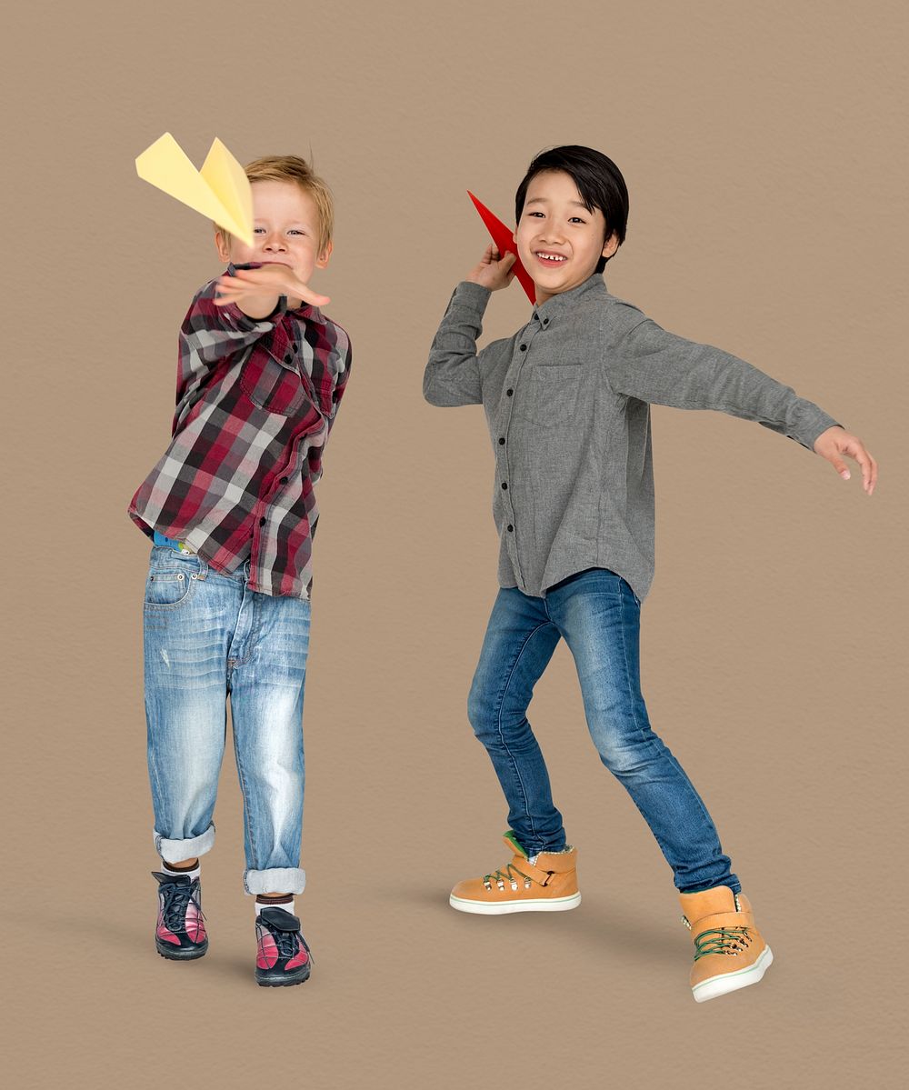 Little Boys Holding Paper Plane Studio Portrait