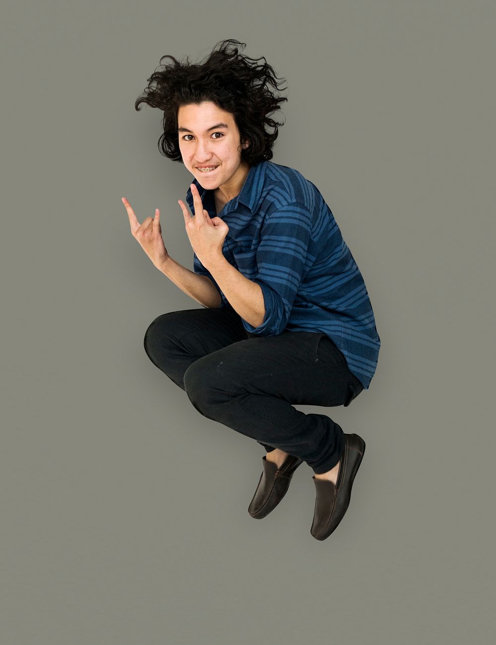 Young Adult Man Jumping Studio Portrait